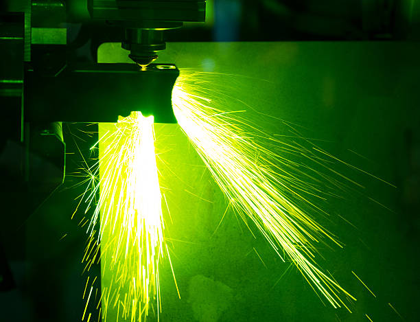 industrial laser cutter with sparks.