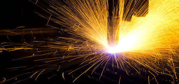 a closeup of a plasma cutter cutting sheet metal